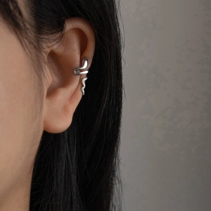 Minimalist silver snake ear cuff wrap earring shown on model with polished metal finish