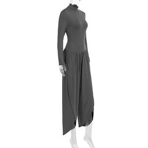 Detail view of dark grey long sleeve jumpsuit with turtleneck and layered wide-leg pants