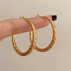Golden woven textured hoop earrings in a vintage twisted metal design for daily wear