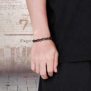 Close-up of retro geometric thick chain bracelet in black finish with hook clasp on wrist