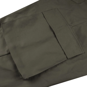 Detail of cargo pants showing the large military olive green side pocket with flap