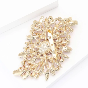 Detailed back view of gold alloy brooch showing intricate hollow design and secure pin