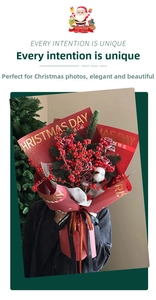 Detail of red Christmas gift wrap with gold foil lettering and festive bouquet decorations