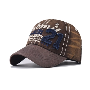 Detail of vintage washed brown baseball cap with blue number 21 embroidery and worn texture