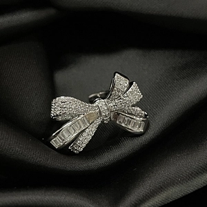 Macro close-up of a luxury bow ring set with sparkling rectangle and round crystals