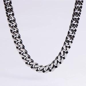 Macro shot of polished stainless steel Cuban chain link necklace with high metal luster