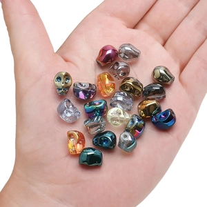 Handheld view of 8x10mm colorful crystal skull beads for DIY Halloween jewelry making
