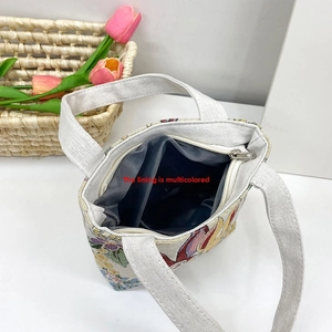 Detail view of the spacious inner lining and secure zipper closure of this floral tote bag