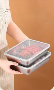 Close-up of stackable stainless steel food containers with transparent lids for storage