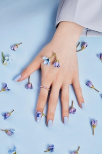 Close-up of a delicate S925 silver ring featuring colorful zircon stones on a model's hand