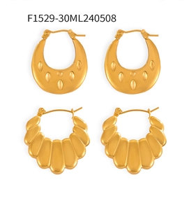 Detail view of gold titanium U-shaped earrings with leaf texture and scalloped shell design