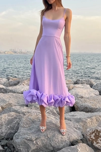 Close-up of lavender camisole dress featuring elegant multi-layered ruffled hem and fluid fabric