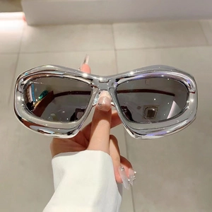 Detail of silver metallic frame and dark lenses on Y2K futuristic oversized sunglasses