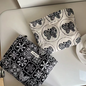 Artistic canvas cosmetic bags featuring elegant floral embroidery and metal zippers