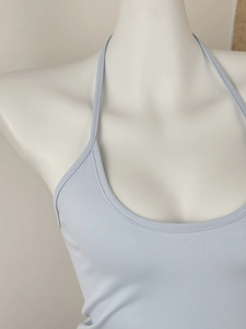 Detail view of light blue knitted halter top neck and slim-fit ribbed fabric on mannequin