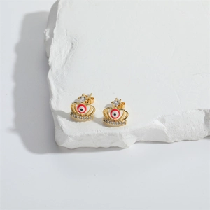 Exquisite gold crown stud earrings with devil's eye design and white zircon on stone