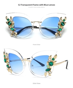 Detail of cat eye sunglasses with blue gradient lenses and jewel-encrusted leaf frames