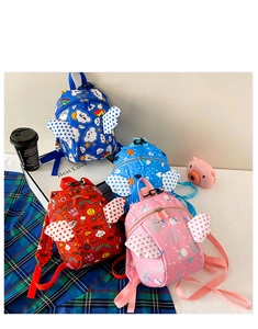 Detail showing colorful toddler backpacks with wings in navy, blue, red and pink