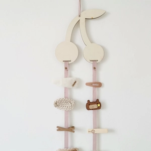 Wall-mounted cherry wooden hair clip organizer with pink ribbons for hair accessories