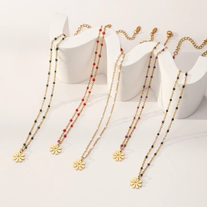 Bohemian daisy petal pendant necklace in five colors on a white wave display stand