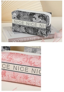 Detail of floral PVC makeup bags in black and pink with printed decorative ribbon