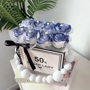 Detail of blue and white gradient soap roses in a luxury gift box with pearl handle