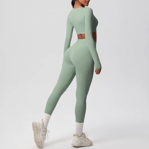 Side view of sage green yoga set with long sleeve crop top and high waist leggings