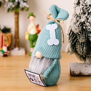 Christmas plush gnome with dog bone hat and wooden sign in festive holiday home setting