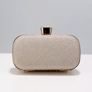 Elegant gold sequin evening clutch bag with diamond-encrusted metal clasp for formal events