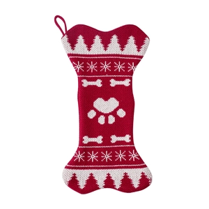 Knitted bone-shaped Christmas stocking with red snowflake and paw print patterns