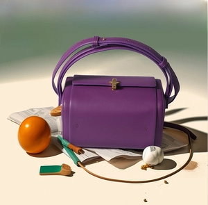 Vue détaillée du sac Boston violet avec fermoir doré et texture en cuir lisse