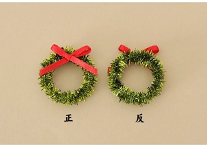 Front and back detail of miniature green Christmas wreath with small red ribbon bow