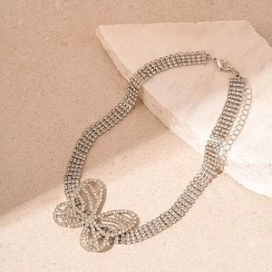 Detail view of silver multi-row rhinestone butterfly choker with adjustable lobster clasp