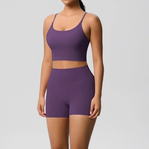 Close-up of seamless dark purple sports bra and high-waisted shorts yoga set on model