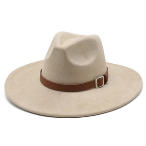 Close-up of beige suede wide brim fedora with brown braided leather band and silver buckle