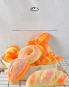 Detailed assortment of artificial PU bread and realistic pastry models in a woven basket