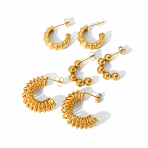 Three pairs of gold stainless steel hoop earrings with textured and beaded spiral designs