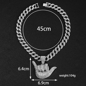 Detail view of a silver shaka gesture pendant with clear rhinestones on a 45cm Cuban chain