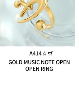 Detailed close-up of a gold-plated titanium steel ring with minimalist spherical ends