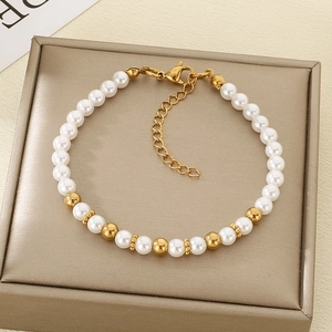 Detailed view of pearl and gold beaded bracelet on a premium jewelry display box