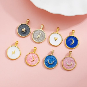 Detail showing colorful enamel alloy charms with star moon and heart designs on pink surface
