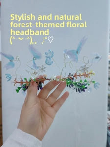 Close-up of handmade floral headband with blue butterflies, pearls and gold wire detail