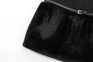 Detail of black faux fur dress with waist belt showing silver eyelets and soft texture