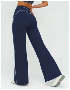 Rear view of navy blue high-waisted flared yoga pants with white contrast piping details