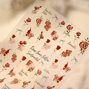 Close-up of TS-4247 French red rose nail stickers with elegant bow and script designs