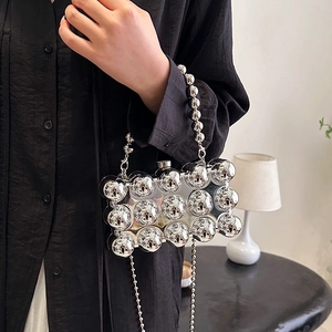 Silver metallic acrylic clutch bag with bold 3D spherical studs and chain strap