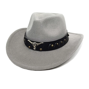 Detail of dark grey western cowboy hat with a metal bull head icon on a studded leather band