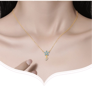 Detailed view of an S925 silver gold necklace with a blue flower pendant worn on the neck