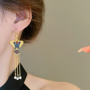 Elegant gold plated butterfly lotus earrings with enamel details and long tassels