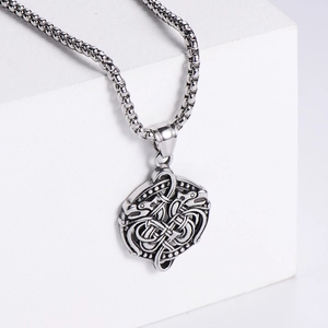 Detail of Viking Celtic knot pendant in vintage silver finish on a white stone
